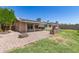 Backyard featuring a grill, a stone fireplace, and desert landscaping at 2423 E Dahlia Dr, Phoenix, AZ 85032