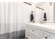 Bathroom featuring a white vanity with framed mirror, and a shower with a neutral patterned curtain at 2423 E Dahlia Dr, Phoenix, AZ 85032
