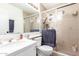 Bright bathroom featuring a white vanity, toilet, and glass-enclosed shower at 2423 E Dahlia Dr, Phoenix, AZ 85032
