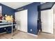 bedroom features blue walls, a loft bed and an adjacent closet at 2423 E Dahlia Dr, Phoenix, AZ 85032