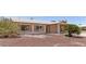 Single-story home featuring desert landscaping, shutters, and a covered carport at 2423 E Dahlia Dr, Phoenix, AZ 85032