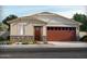 Charming single-story home featuring a neutral color palette, brick accents, and a two-car garage at 24633 W Bowker St, Buckeye, AZ 85326