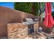 Outdoor grill area in backyard, with stone accents and built-in features at 25633 N 71St Dr, Peoria, AZ 85383