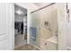 Shower in bathroom includes a bench and a glass door next to a walk-in closet at 25633 N 71St Dr, Peoria, AZ 85383