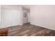 Bedroom featuring wood floors, closet, and two windows with wood shutters at 25633 N 71St Dr, Peoria, AZ 85383