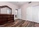 Cozy bedroom featuring wood floors, closet, and dresser with mirror at 25633 N 71St Dr, Peoria, AZ 85383