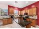 Beautiful kitchen featuring dark granite countertops, modern appliances, and ample lighting at 25633 N 71St Dr, Peoria, AZ 85383