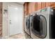 Laundry room with side-by-side washer and dryer, and cabinets at 25633 N 71St Dr, Peoria, AZ 85383