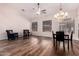 Spacious living room featuring dark wood floors, lots of natural light and modern ceiling fan at 25633 N 71St Dr, Peoria, AZ 85383