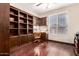 Office space with built-in shelves, desk, and window at 25633 N 71St Dr, Peoria, AZ 85383