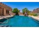 Backyard pool view featuring a waterfall feature and lush landscaping at 25633 N 71St Dr, Peoria, AZ 85383