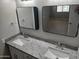 Modern bathroom featuring a granite countertop with dual sinks and contemporary black-trimmed mirrors at 3104 E Broadway Rd # 348, Mesa, AZ 85203