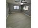 Bedroom features a ceiling fan, natural light, and neutral-toned walls at 3104 E Broadway Rd # 348, Mesa, AZ 85203