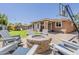 Inviting backyard with a built-in fire pit and a playground, perfect for outdoor gatherings at 3173 N Clanton St, Buckeye, AZ 85396