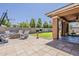 Large backyard featuring a built-in fire pit, covered patio, and well-maintained landscaping at 3173 N Clanton St, Buckeye, AZ 85396