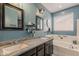 Bright bathroom with a double sink vanity and a soaking tub, accented with unique decor at 3173 N Clanton St, Buckeye, AZ 85396
