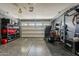 View of an organized garage with epoxy flooring and shelving along the walls at 3173 N Clanton St, Buckeye, AZ 85396