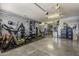 Epoxy garage with exercise equipment, including a treadmill and free weights, for home workouts at 3173 N Clanton St, Buckeye, AZ 85396