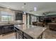 Open kitchen featuring an island, breakfast bar, modern finishes, and stainless appliances at 3173 N Clanton St, Buckeye, AZ 85396