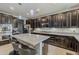 Gourmet kitchen with stone countertops, a central island, and stainless steel appliances at 3173 N Clanton St, Buckeye, AZ 85396