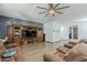 Spacious living room features a ceiling fan, wood flooring, and custom entertainment center at 3173 N Clanton St, Buckeye, AZ 85396