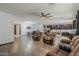 Open floor plan flows into the dining and kitchen area with wood flooring at 3173 N Clanton St, Buckeye, AZ 85396