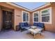 Outdoor patio with slate tile table, comfortable seating, and a cozy fire pit feature at 3173 N Clanton St, Buckeye, AZ 85396