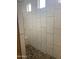 Shower features tile surround, pebble floor and built in bench seat at 3211 W Pollack St, Phoenix, AZ 85041