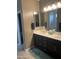 Bathroom featuring double sink vanity, tile floor and a walk-in shower at 3211 W Pollack St, Phoenix, AZ 85041