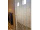 Shower features tile surround, pebble floor and built in bench seat at 3211 W Pollack St, Phoenix, AZ 85041