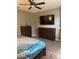 Bedroom with dark wood furniture, TV, ceiling fan, and decorative bedding at 3211 W Pollack St, Phoenix, AZ 85041