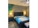 Spacious bedroom with decorative bed coverings, wood furniture and stylish wall art at 3211 W Pollack St, Phoenix, AZ 85041