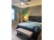 Spacious bedroom with decorative bed coverings, wood furniture and stylish wall art at 3211 W Pollack St, Phoenix, AZ 85041