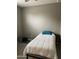 Simple bedroom featuring a twin bed with white comforter and grey wood-look floors at 3211 W Pollack St, Phoenix, AZ 85041
