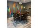 Dining room features wood table set, colorful wall art, and tile floors at 3211 W Pollack St, Phoenix, AZ 85041