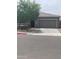 Lovely home featuring a spacious driveway, two-car garage, and desert landscaping at 3211 W Pollack St, Phoenix, AZ 85041