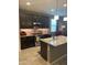Well-lit kitchen with granite counters, stainless steel appliances, and ample cabinet space at 3211 W Pollack St, Phoenix, AZ 85041