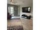 Relaxing living room with access to the patio, showcasing a large television and modern decor at 3211 W Pollack St, Phoenix, AZ 85041