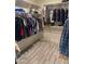 Spacious walk-in closet with shelving, hanging racks, and wood-look flooring offers ample storage at 3211 W Pollack St, Phoenix, AZ 85041