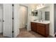 This bathroom boasts wood cabinets, a vanity, and an ample walk-in closet at 4043 E Carla Vista Dr, Gilbert, AZ 85295