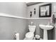 Classic half bath with pedestal sink and decorative mirror at 4043 E Carla Vista Dr, Gilbert, AZ 85295