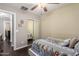 This bedroom boasts a ceiling fan, window with blinds, and mirrored closet doors at 4043 E Carla Vista Dr, Gilbert, AZ 85295