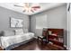 Cozy bedroom featuring stylish daybed, dark wood floors, and a charming bookcase at 4043 E Carla Vista Dr, Gilbert, AZ 85295