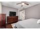 Comfortable bedroom features dark wood floors, a ceiling fan, and ample closet space at 4043 E Carla Vista Dr, Gilbert, AZ 85295