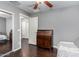 Bright bedroom featuring a wooden desk, ceiling fan, and hardwood-style floors at 4043 E Carla Vista Dr, Gilbert, AZ 85295
