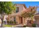 Charming two-story home with a well-maintained lawn, mature trees, and desert landscaping at 4043 E Carla Vista Dr, Gilbert, AZ 85295