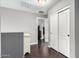Hallway leading to various rooms featuring dark wood floors and a double door closet at 4043 E Carla Vista Dr, Gilbert, AZ 85295