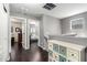 Upstairs hallway with dark wood floors, leading to bedrooms and featuring a painted chest at 4043 E Carla Vista Dr, Gilbert, AZ 85295