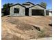 Unfinished exterior view of a single-Gathering home with a two-car garage at 415 S Robert S Rd, Tempe, AZ 85281