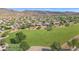 Overhead perspective of lush, green community space, complemented by nearby residential homes and natural desert environment at 4239 W Reddie Loop, Phoenix, AZ 85083